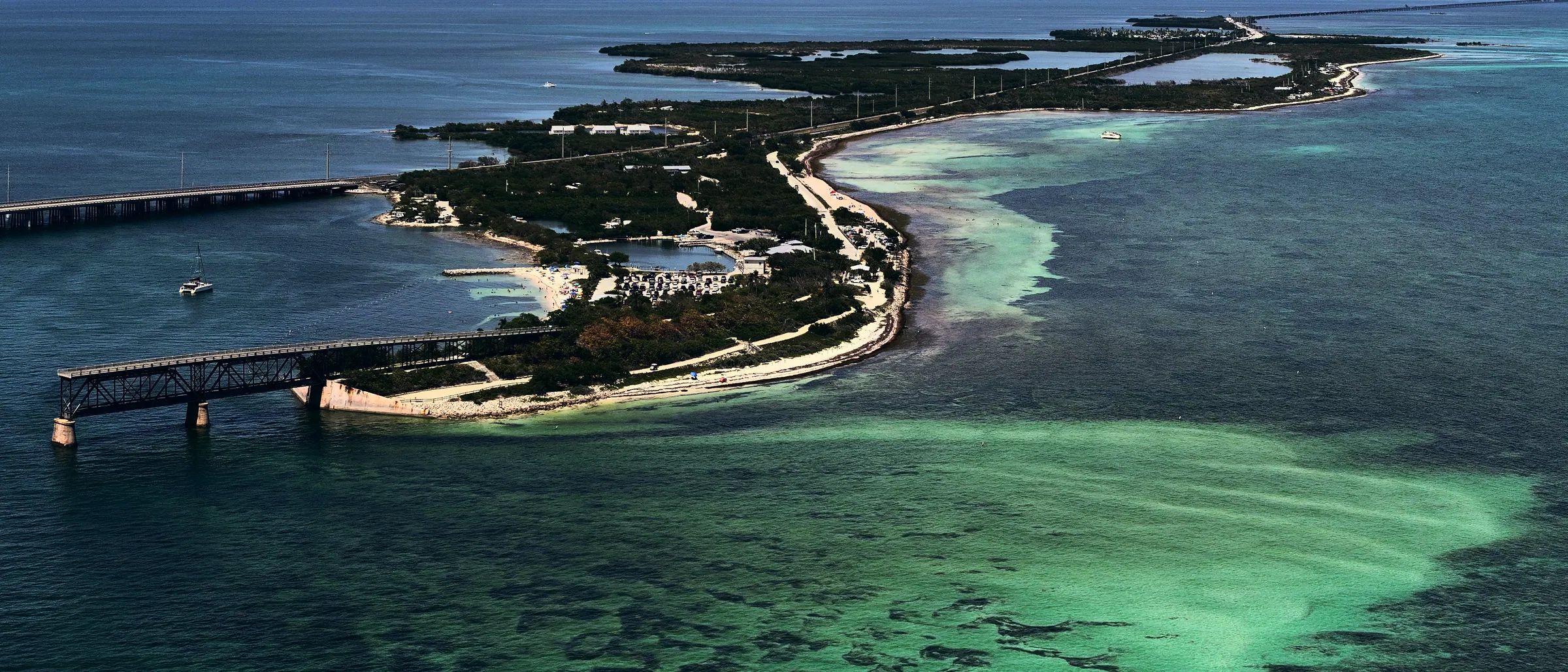 Bahia Honda Key from the air: the highway and the old railway bridge running between turquoise shallows.
